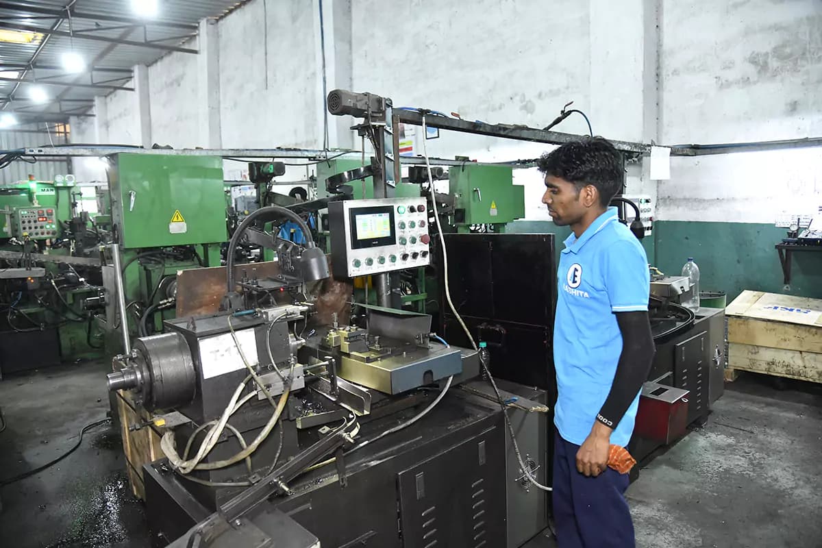 A machine operator working at a precision turning station on the bearing line
